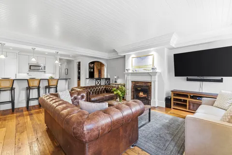 a living room with fireplace furniture and a flat screen tv