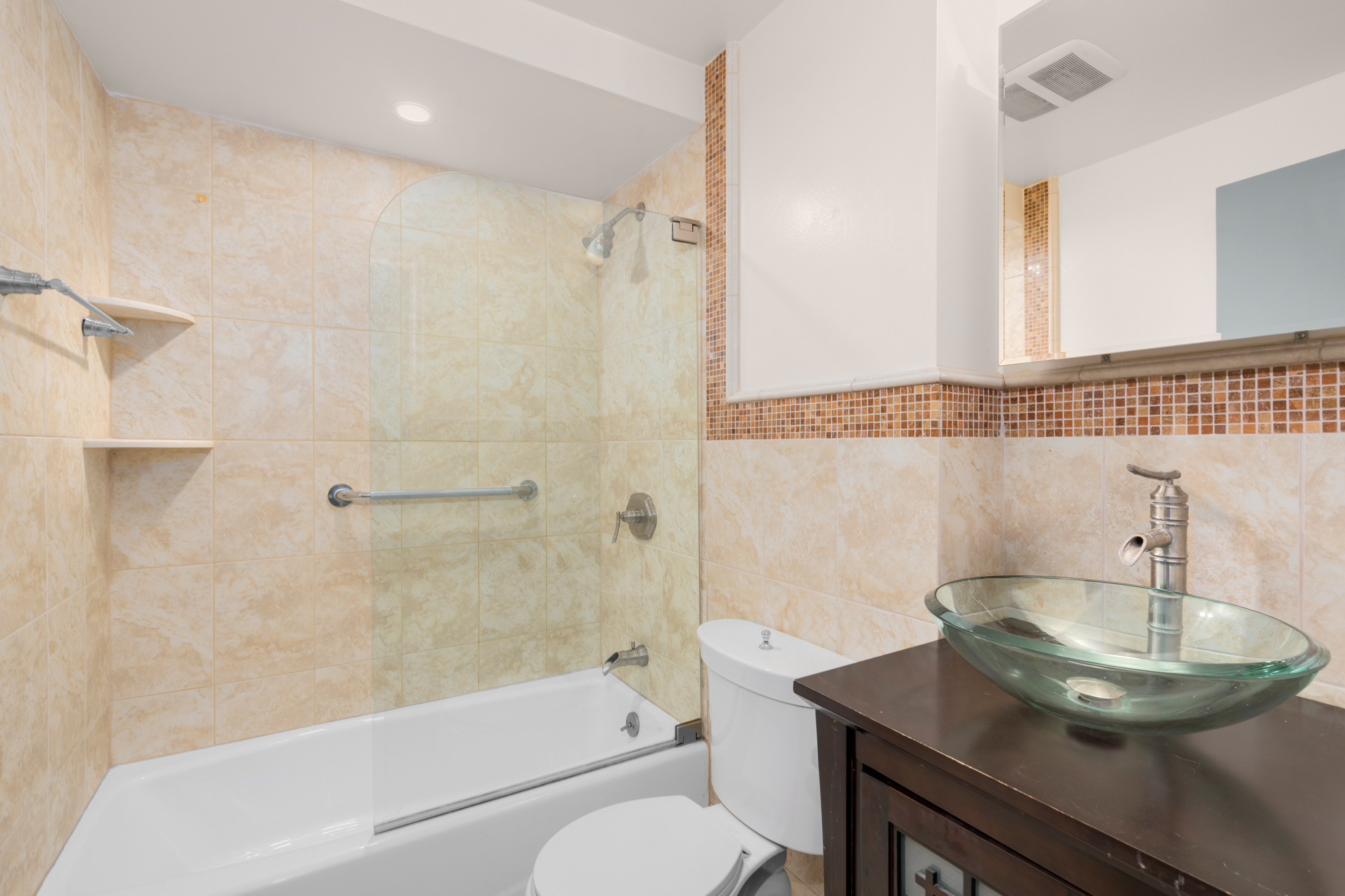 252 West 102nd Street, Unit 1 Manhattan, NY 10025 - Photo 6 of 11 a bathroom with a sink toilet a mirror and shower