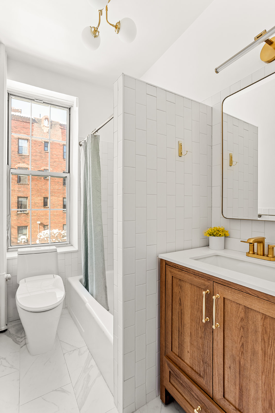 37-51 84th Street, Unit 21 Queens, NY 11372 - Photo 6 of 10 a bathroom with a granite countertop sink toilet and mirror