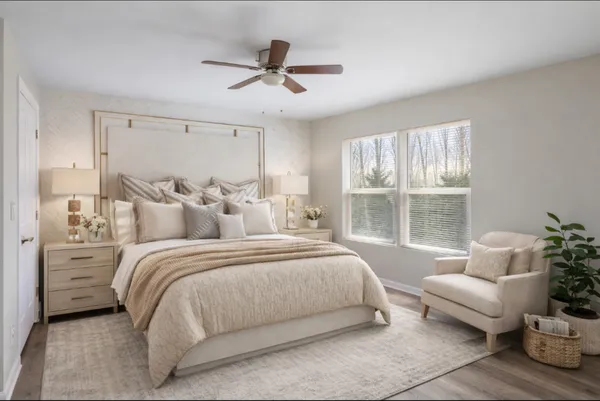 a spacious bedroom with a bed and a large window