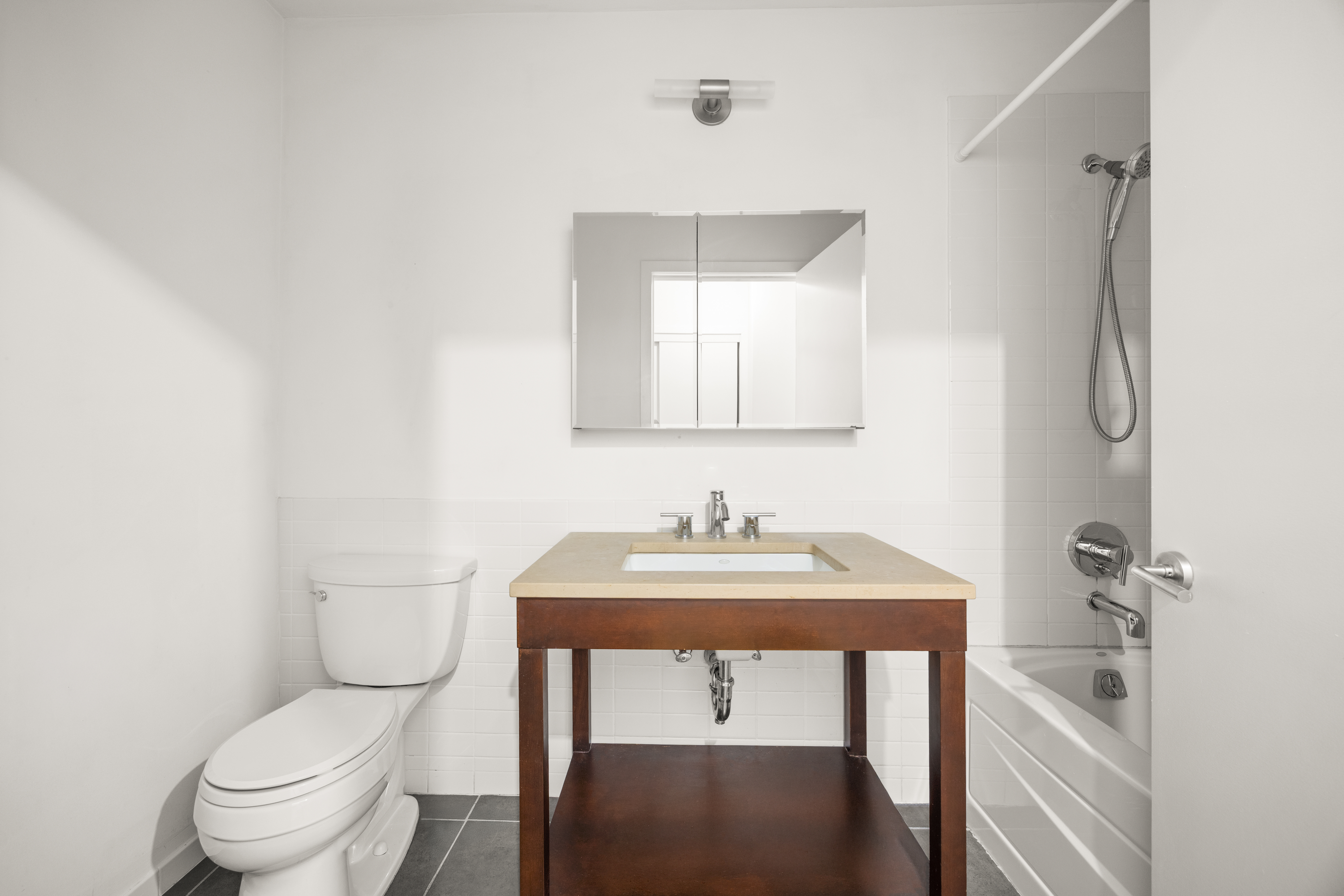 365 Bridge Street, Unit 5N Brooklyn, NY 11201 - Photo 4 of 12 a bathroom with a toilet a sink and mirror