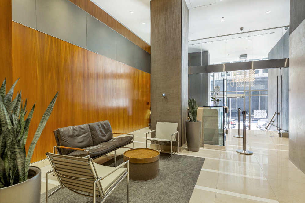 59 John Street, Unit 4H Manhattan, NY 10038 - Photo 18 of 19 a living room with furniture a lamp and a potted plant