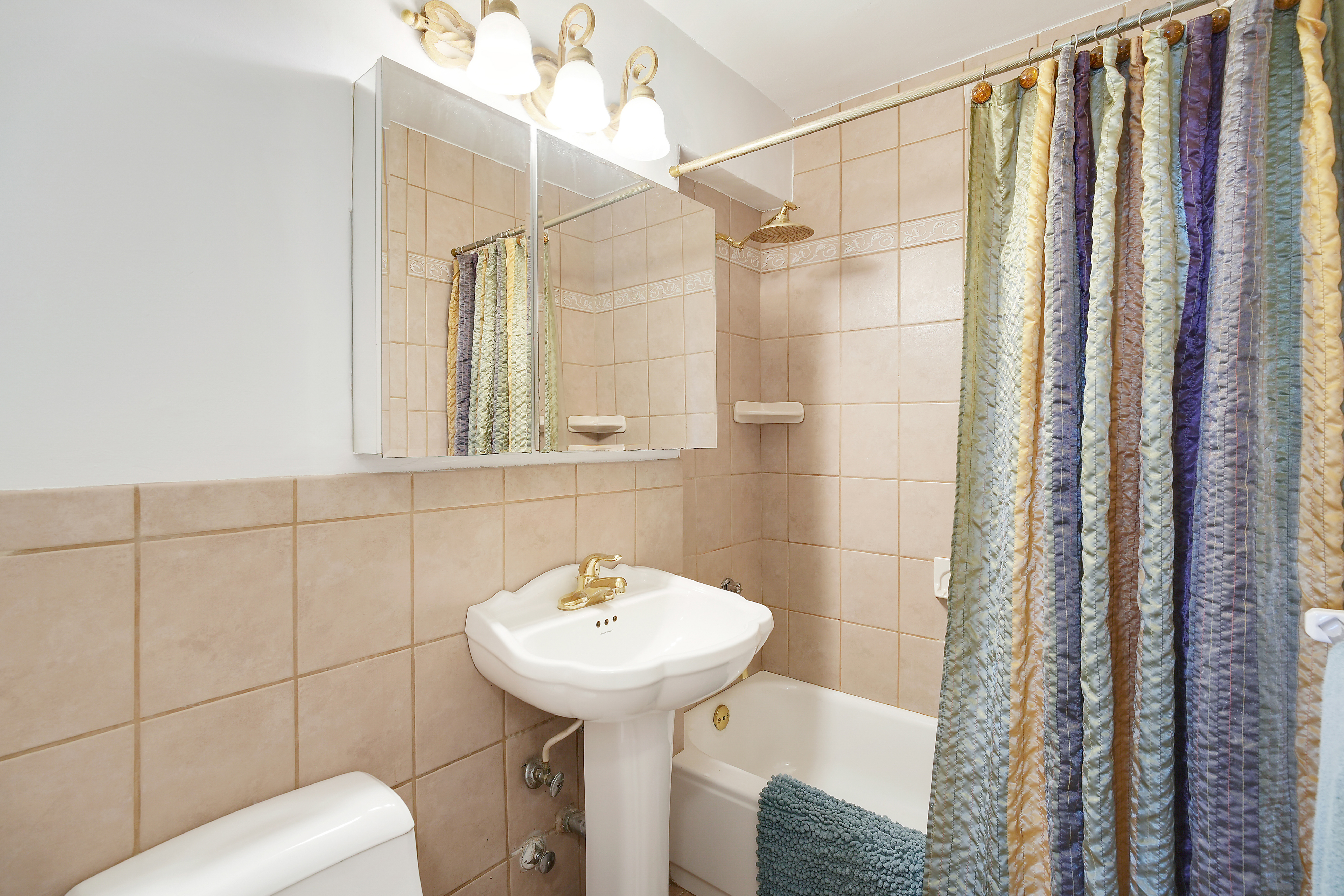5700 Arlington Avenue, Unit 16T Bronx, NY 10471 - Photo 10 of 16 a bathroom with a sink toilet and shower