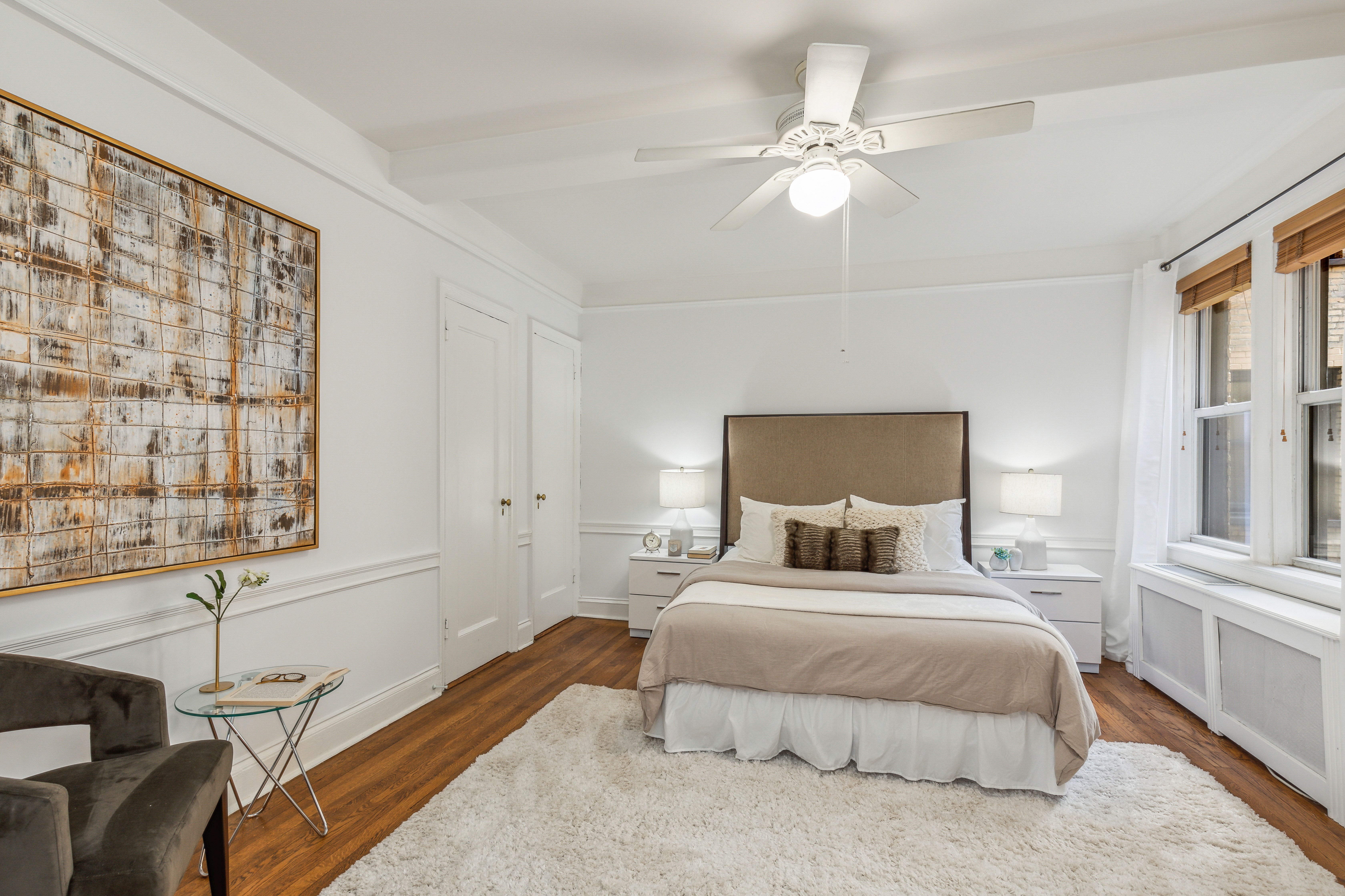 400 East 59th Street, Unit 2D Manhattan, NY 10022 - Photo 5 of 8 a bedroom with a large bed and a chandelier