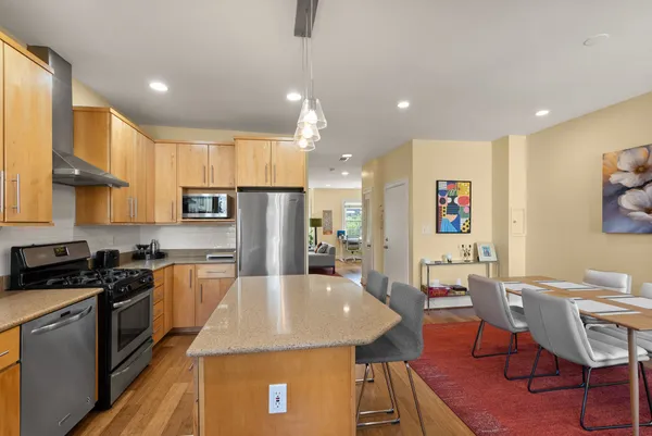 a view of balcony with two chairs and a potted plant