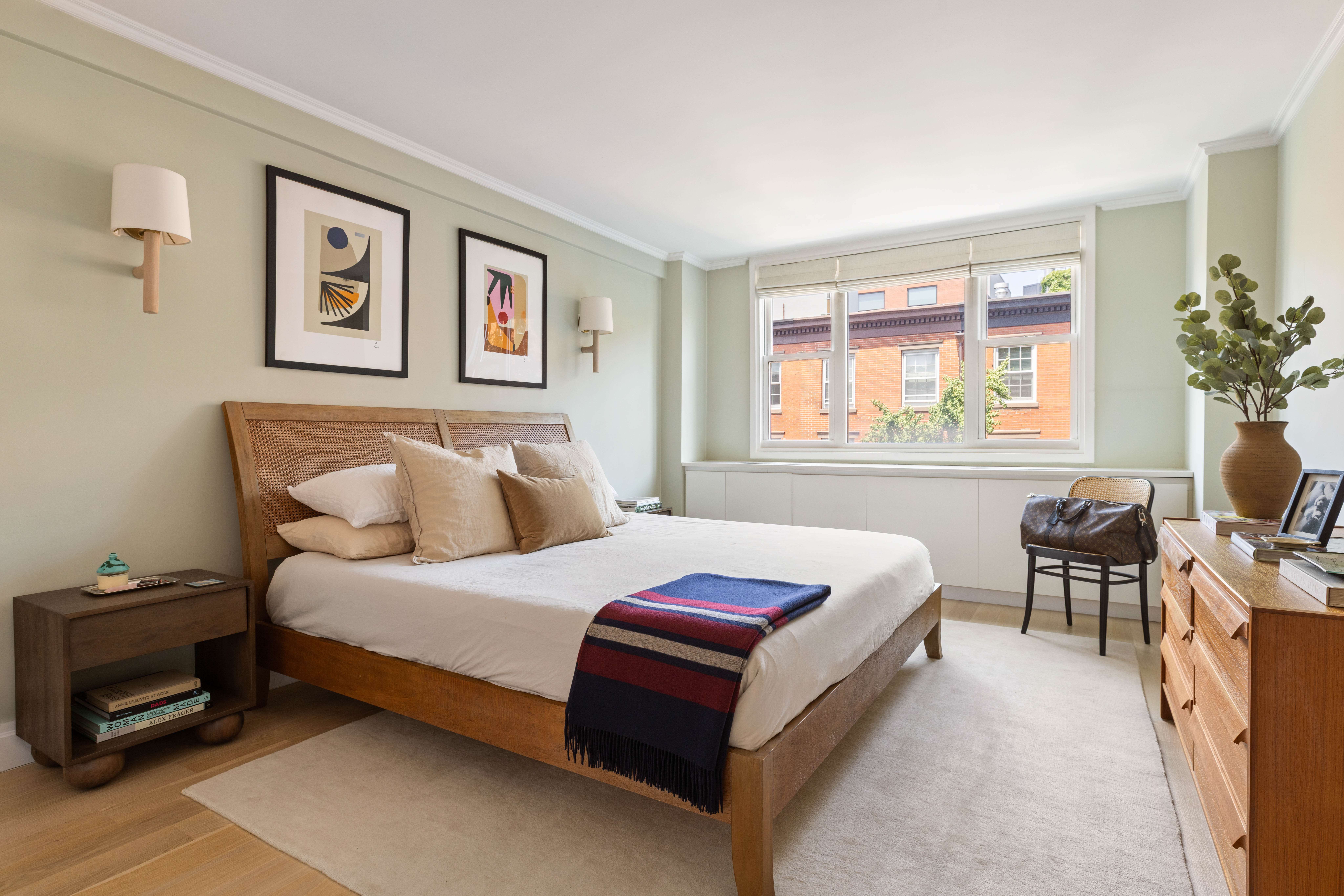 61 Jane Street, Unit 4L Manhattan, NY 10014 - Photo 7 of 11 a bedroom with a bed table chair and painting on the wall