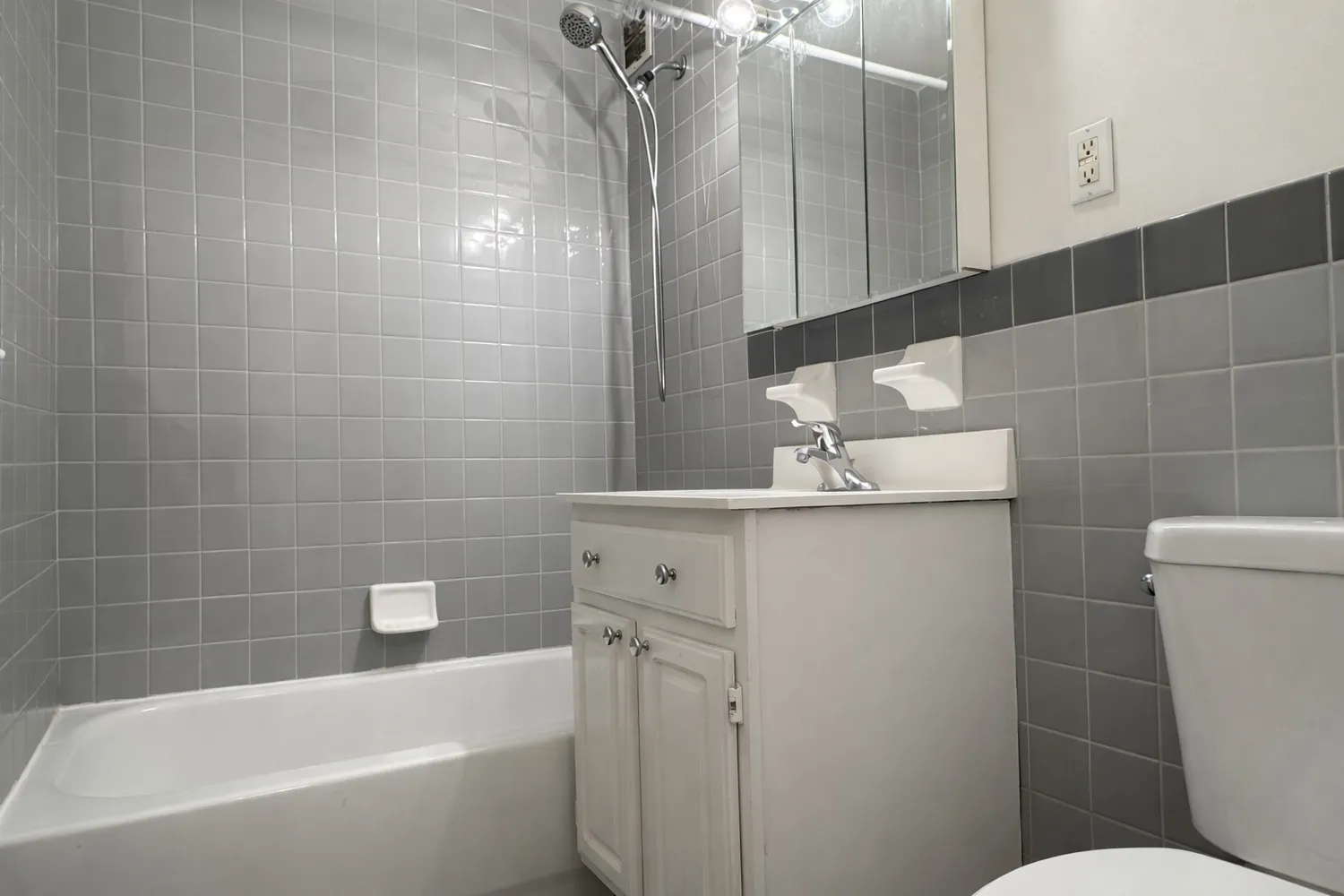 a bathroom with a bathtub a sink a toilet and a mirror