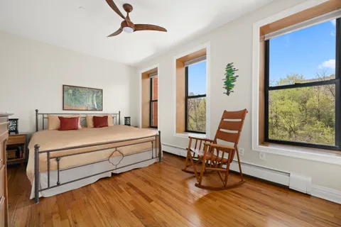 a bedroom with a bed and a large window