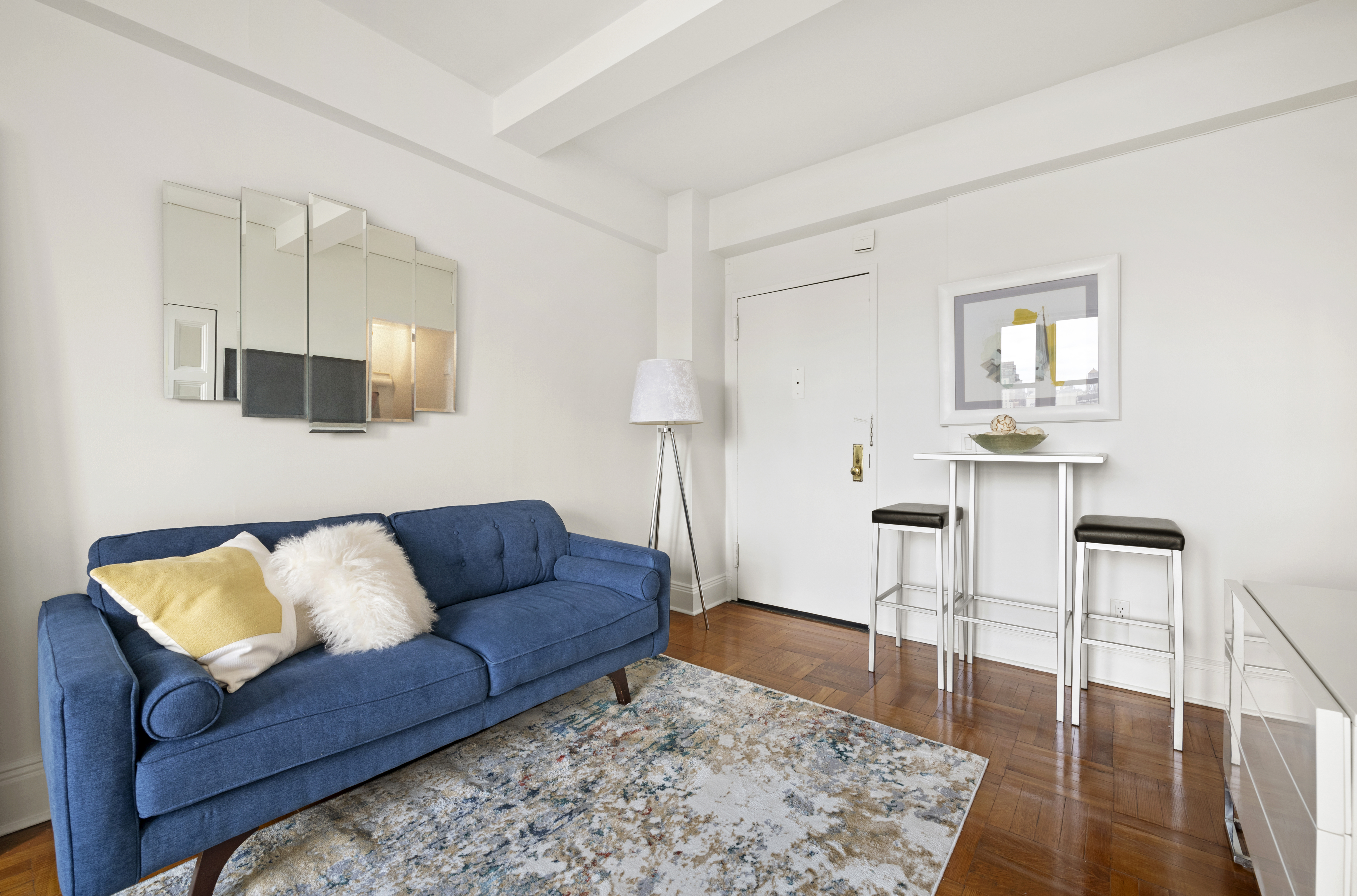 225 Central Park West, Unit 919 Manhattan, NY 10024 - Photo 2 of 15 a living room with furniture and a wooden floor