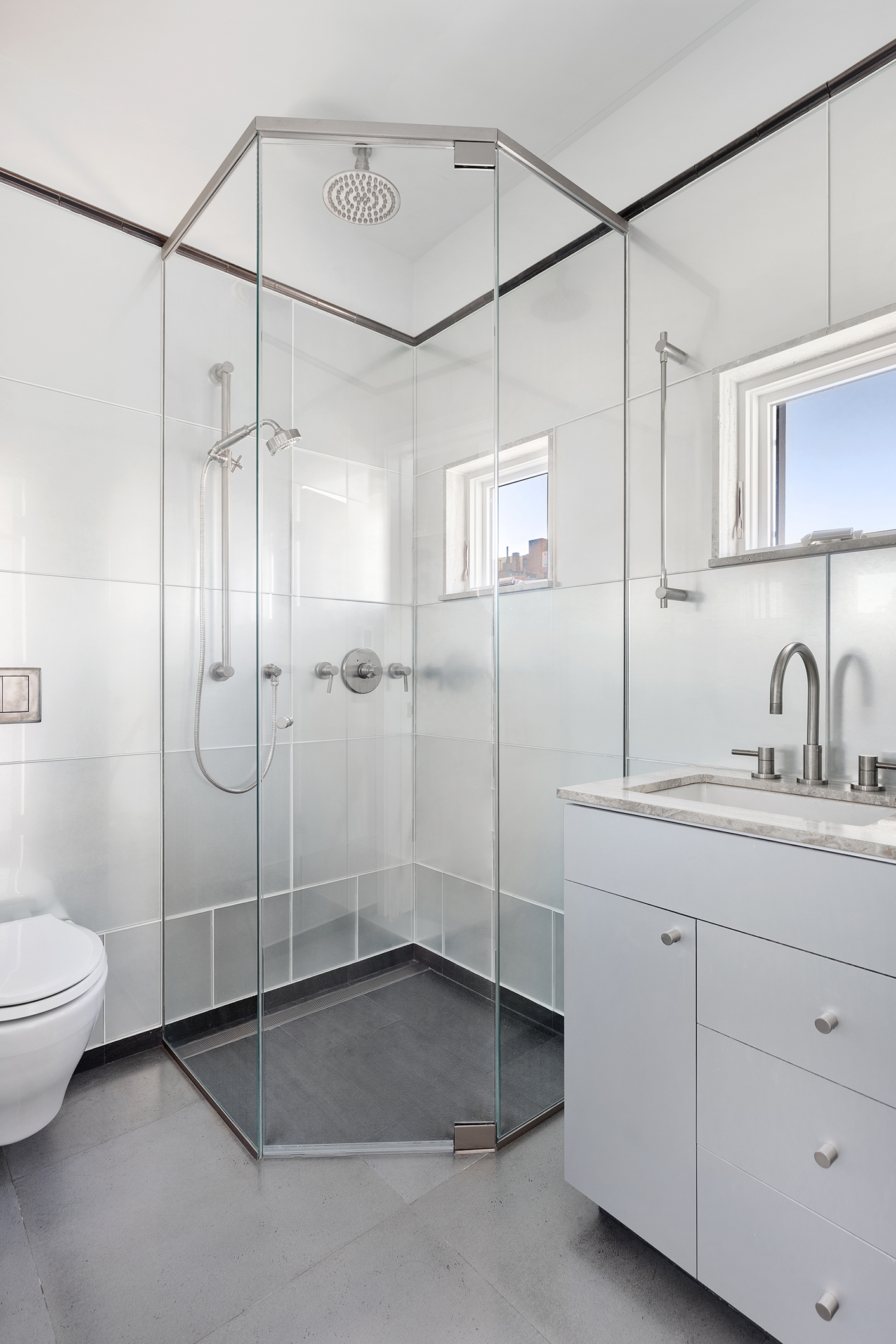 428 Columbus Avenue, Unit PH Manhattan, NY 10024 - Photo 15 of 21 a bathroom with a shower sink vanity and toilet
