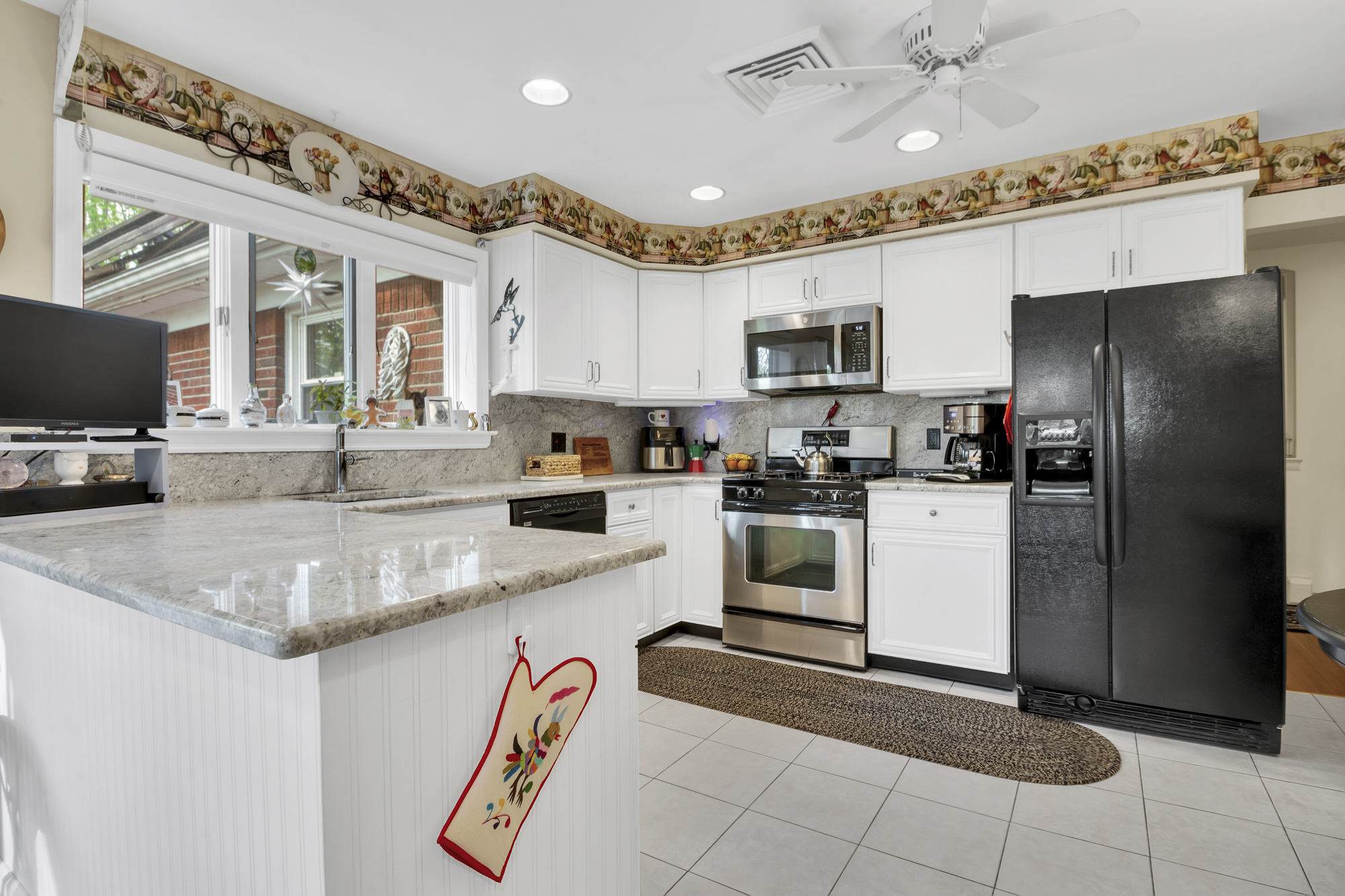 131 Jansen Street Staten Island, NY 10312 - Photo 5 of 21 a kitchen with a refrigerator a sink and a stove top oven