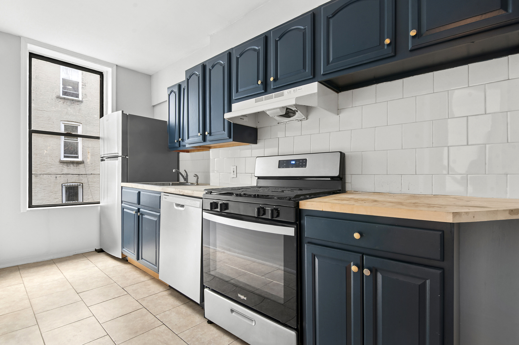 271 6th Avenue, Unit 2 Brooklyn, NY 11215 - Photo 7 of 8 a kitchen with stainless steel appliances granite countertop a stove and a refrigerator