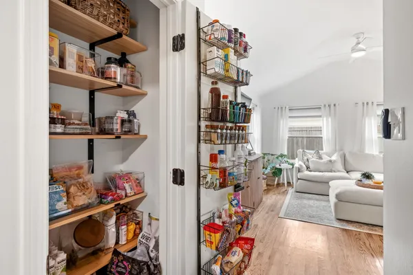 a living room with furniture and a book shelf