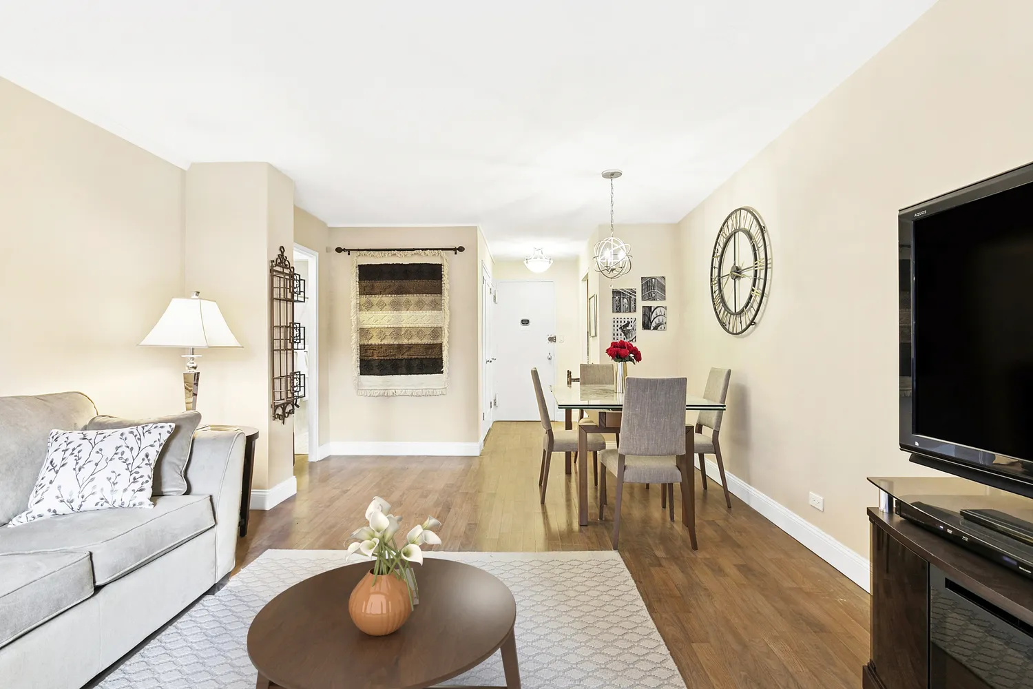 a living room with furniture a rug and a flat screen tv