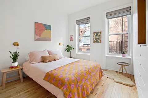 a bedroom with bed and a window