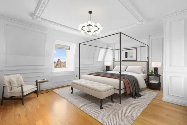 a bedroom with a bed and a chandelier