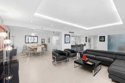 a living room with furniture and a floor to ceiling window