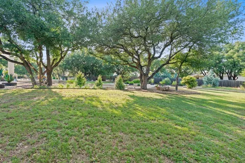 a view of outdoor space with garden and trees