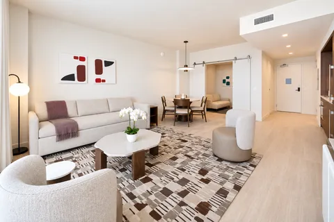 a living room with furniture and a rug