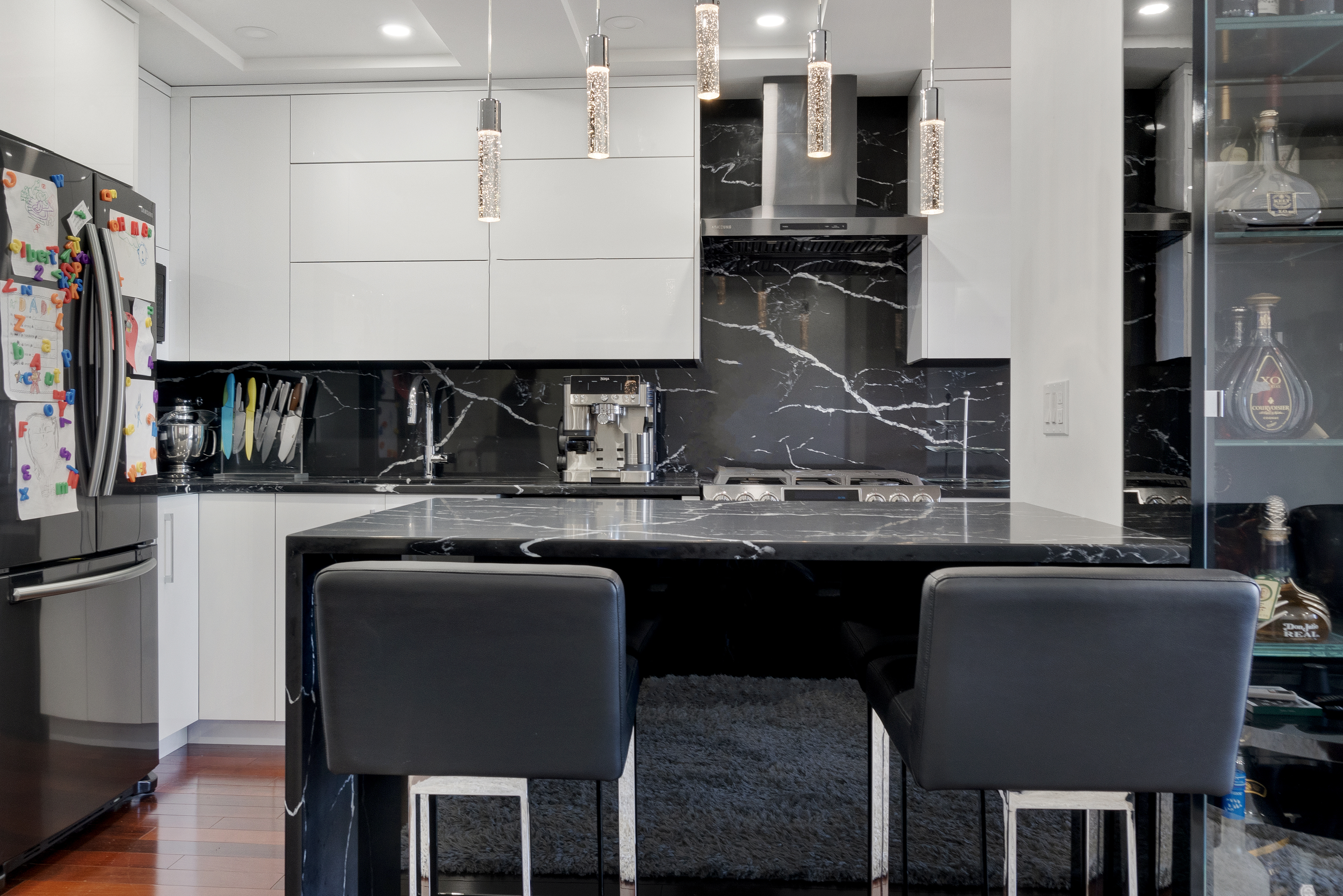448 Neptune Avenue, Unit 14L Brooklyn, NY 11224 - Photo 3 of 20 a kitchen with a table chairs sink and cabinets