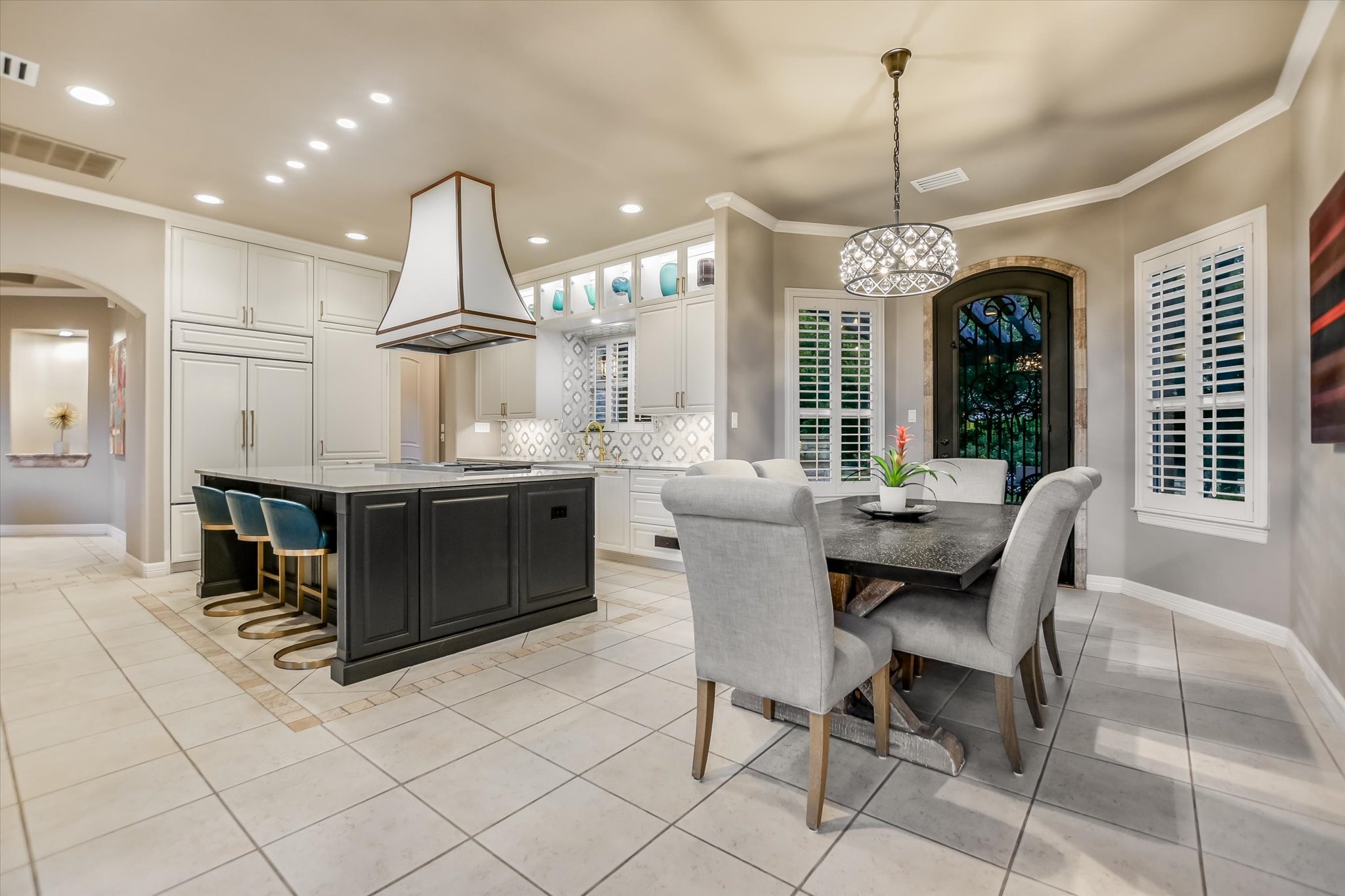 1422 Palomino Ridge Drive Austin, TX 78733 - Photo 14 of 60 a dining hall with stainless steel appliances kitchen island granite countertop a table chairs and a view of living room
