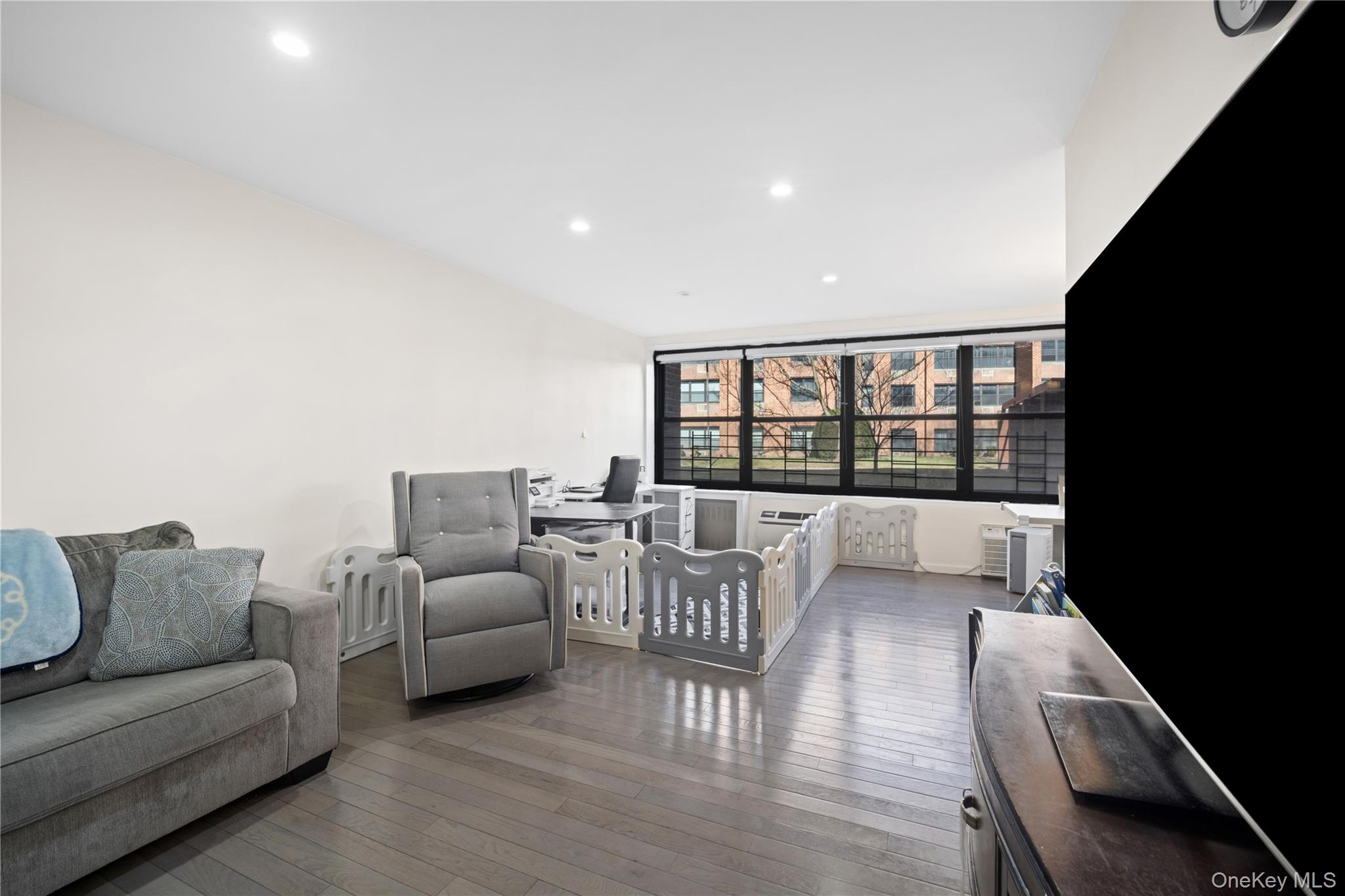 75-34 Bell Boulevard, Unit LD Queens, NY 11364 - Photo 21 of 26 a living room with furniture and a large window