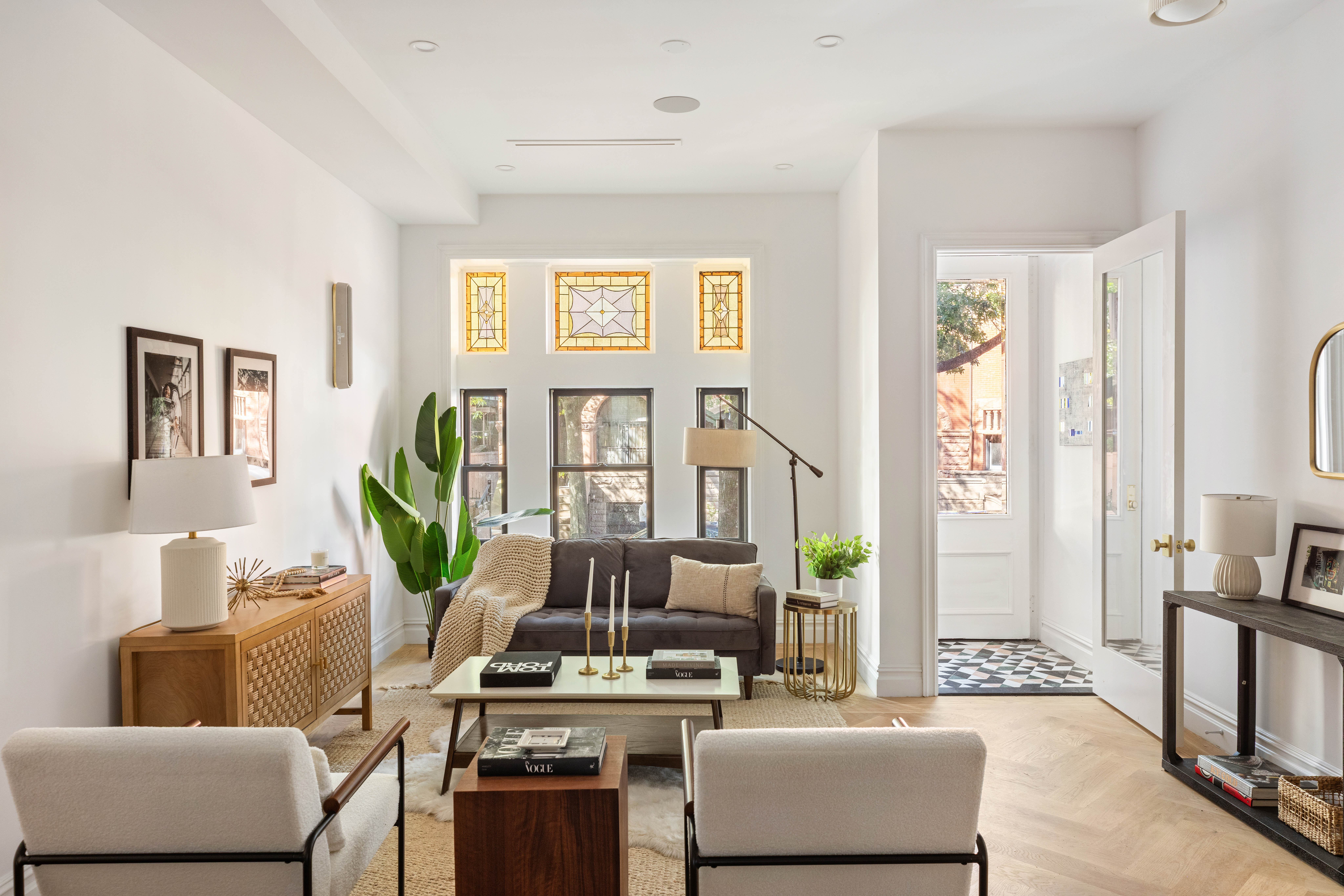 a living room with furniture and a wooden floor