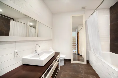 a bathroom with a sink a bathtub and a shower