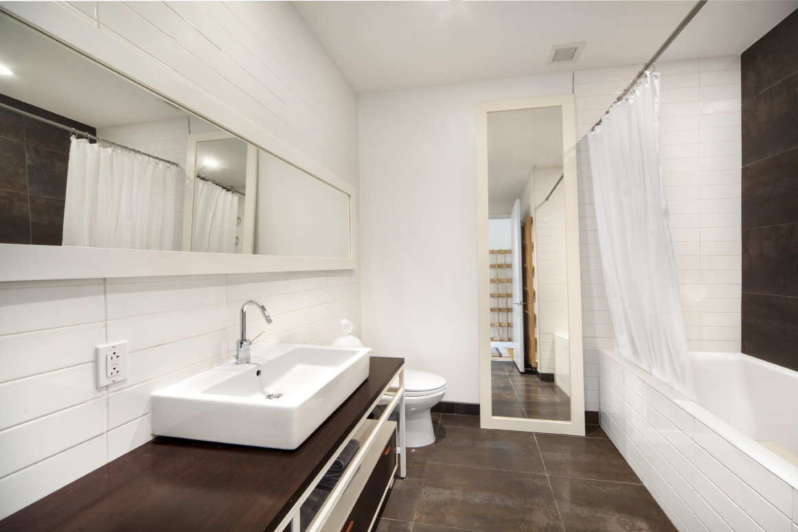 420 West 25th Street, Unit 3B Manhattan, NY 10001 - Photo 6 of 15 a bathroom with a sink a bathtub and a shower