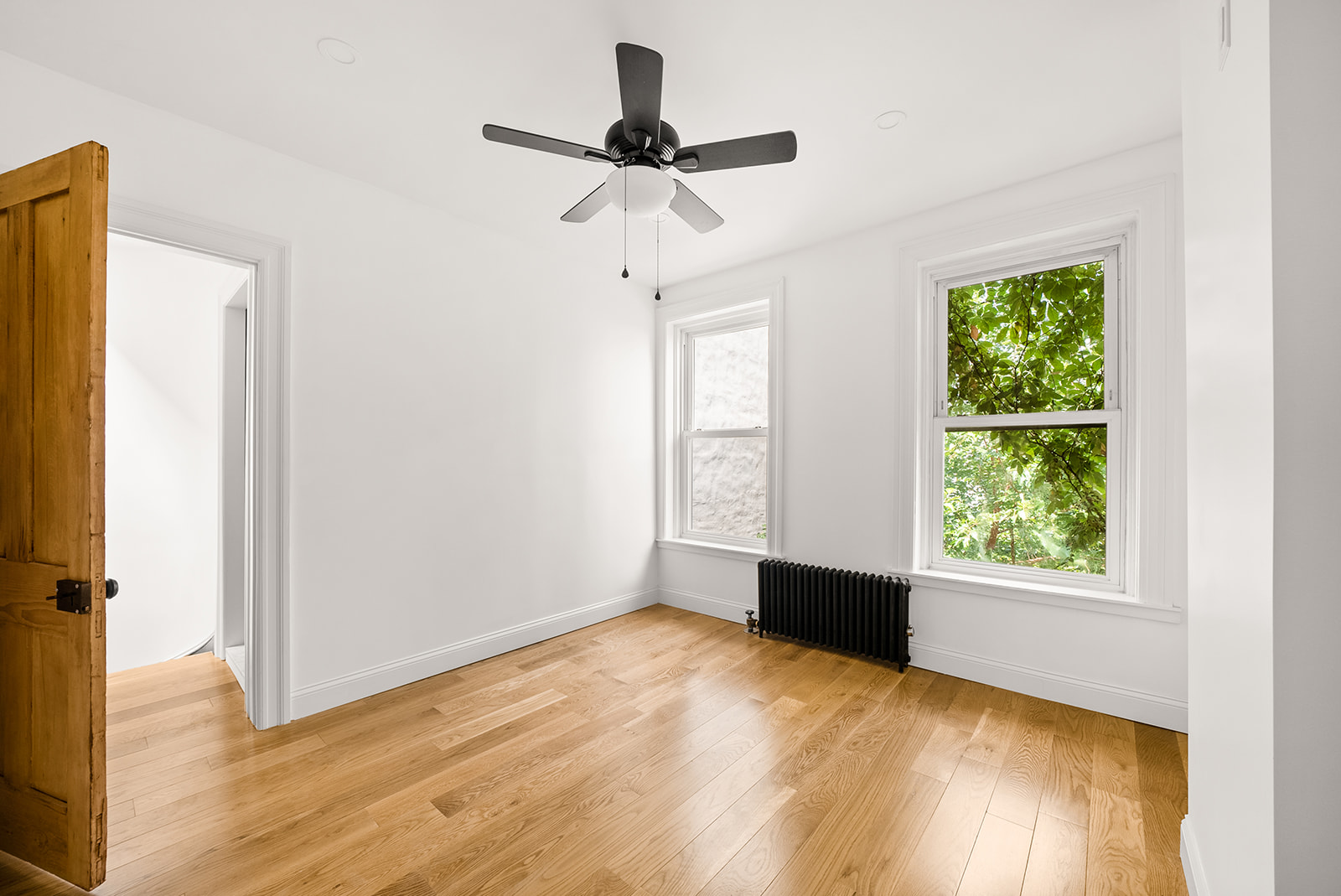 211 12th Street, Unit 2 Brooklyn, NY 11215 - Photo 3 of 7 a view of empty room with wooden floor and fan