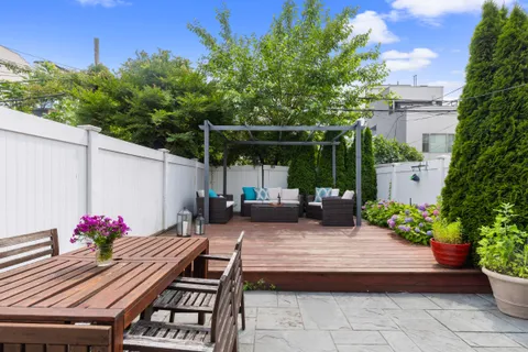 a view of a backyard with sitting area