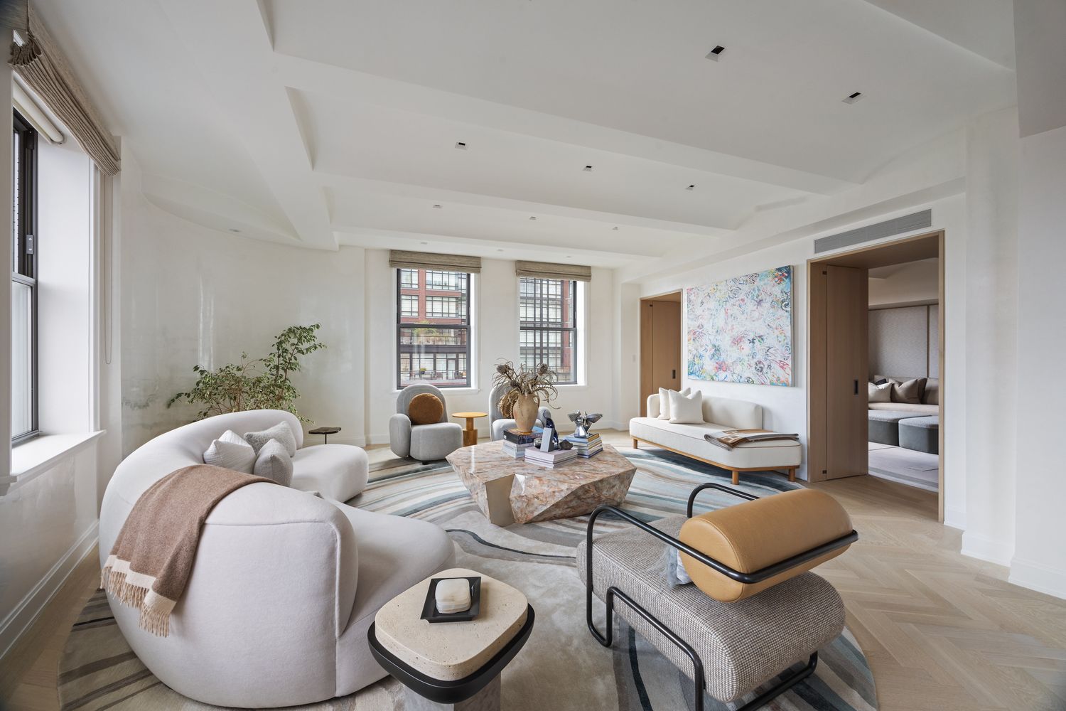 a living room with furniture and wooden floor