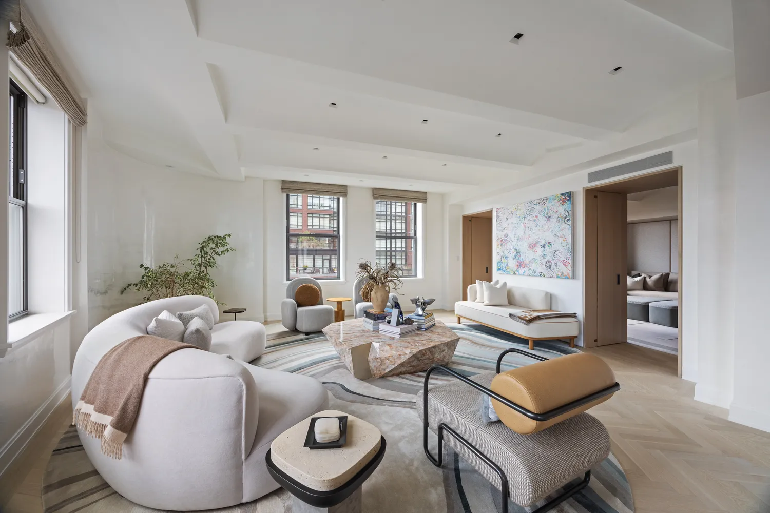 a living room with furniture and wooden floor