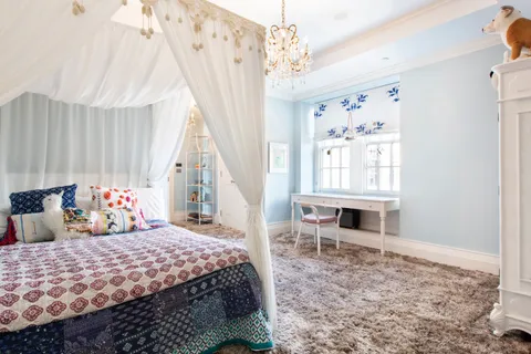 a bedroom with a bed wooden floor and window