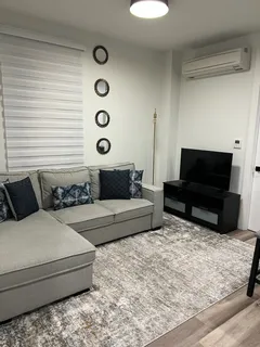 a living room with furniture and a flat screen tv