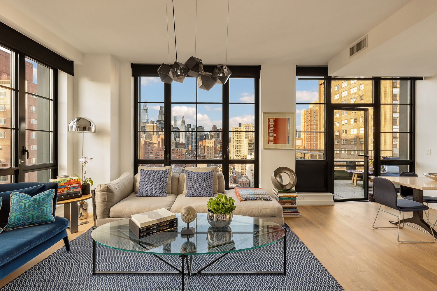 a living room with furniture and floor to ceiling windows