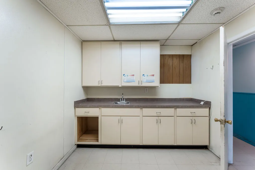 a utility room with cabinets washer and dryer