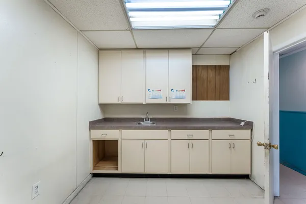 a utility room with cabinets washer and dryer