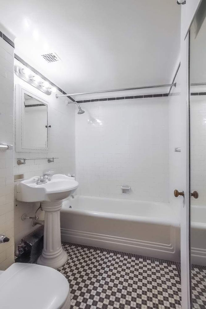 340 West 57th Street, Unit 14E Manhattan, NY 10019 - Photo 12 of 13 a bathroom with a sink toilet and shower