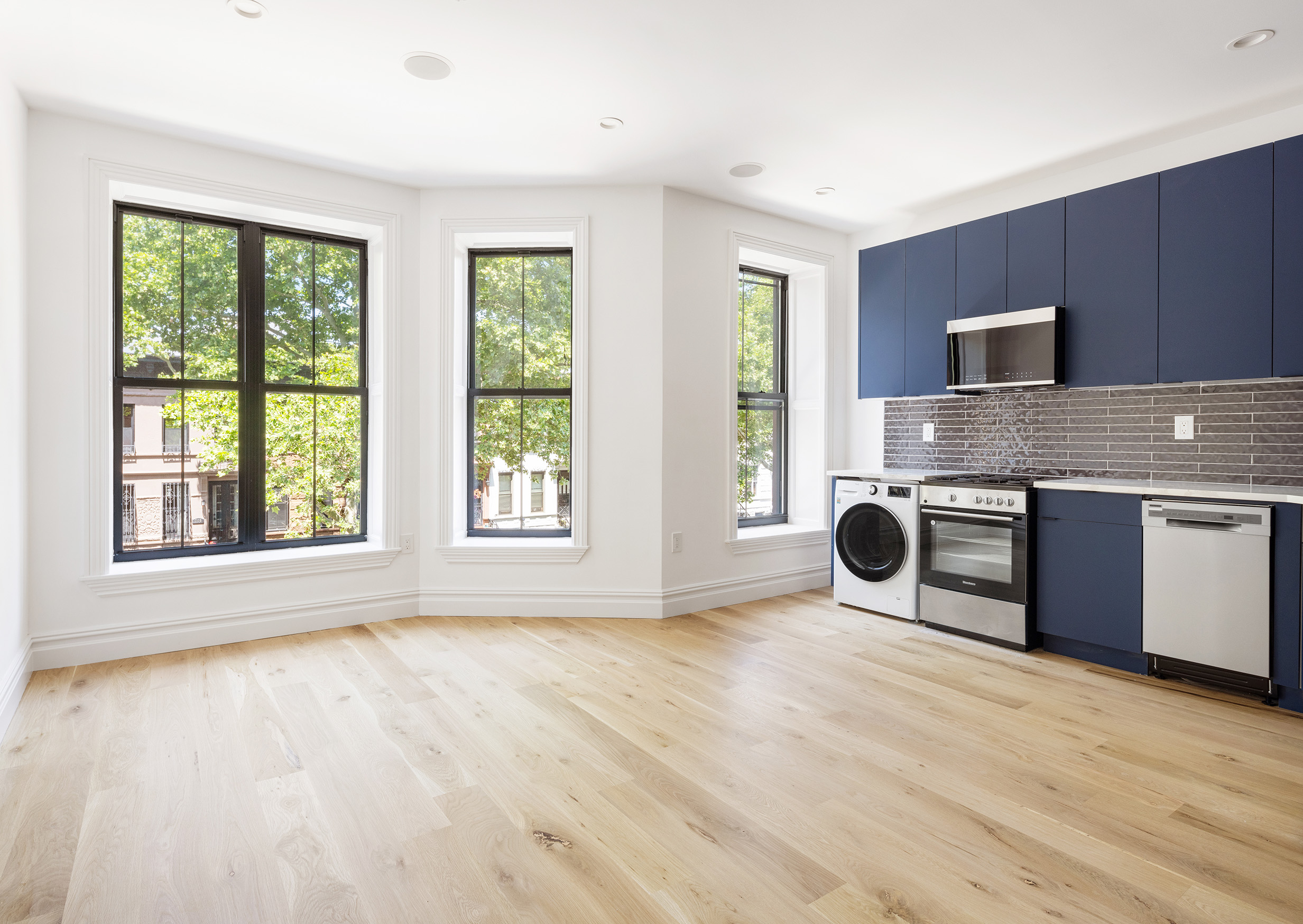 698 Macon Street Brooklyn, NY 11233 - Photo 13 of 17 a kitchen with stainless steel appliances granite countertop a stove a sink and a microwave oven with cabinets