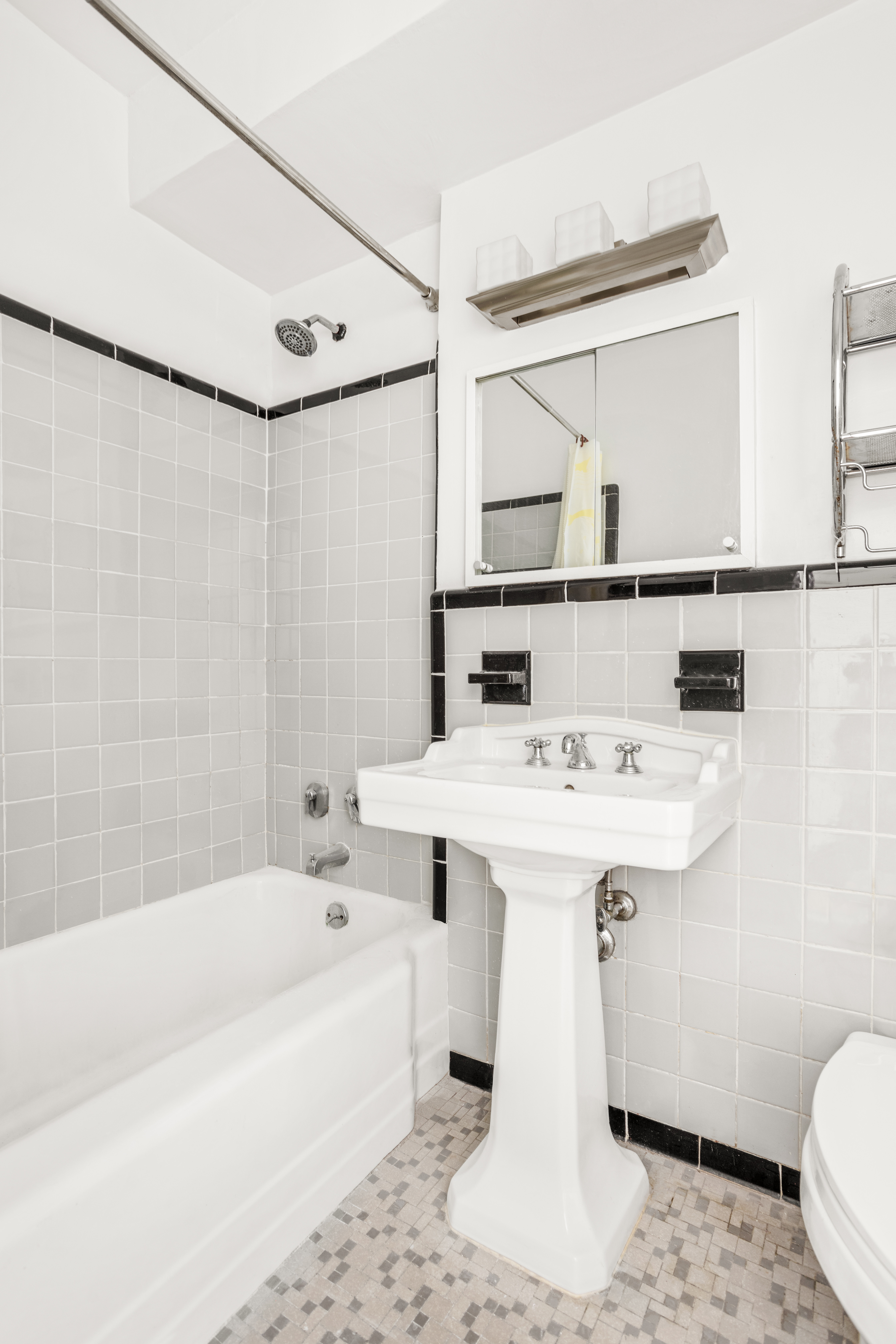 310 East 49th Street, Unit 7B Manhattan, NY 10017 - Photo 7 of 10 a bathroom with a sink a toilet and a bathtub