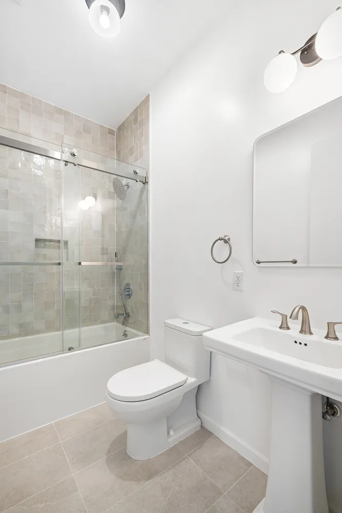 a bathroom with a sink toilet and shower