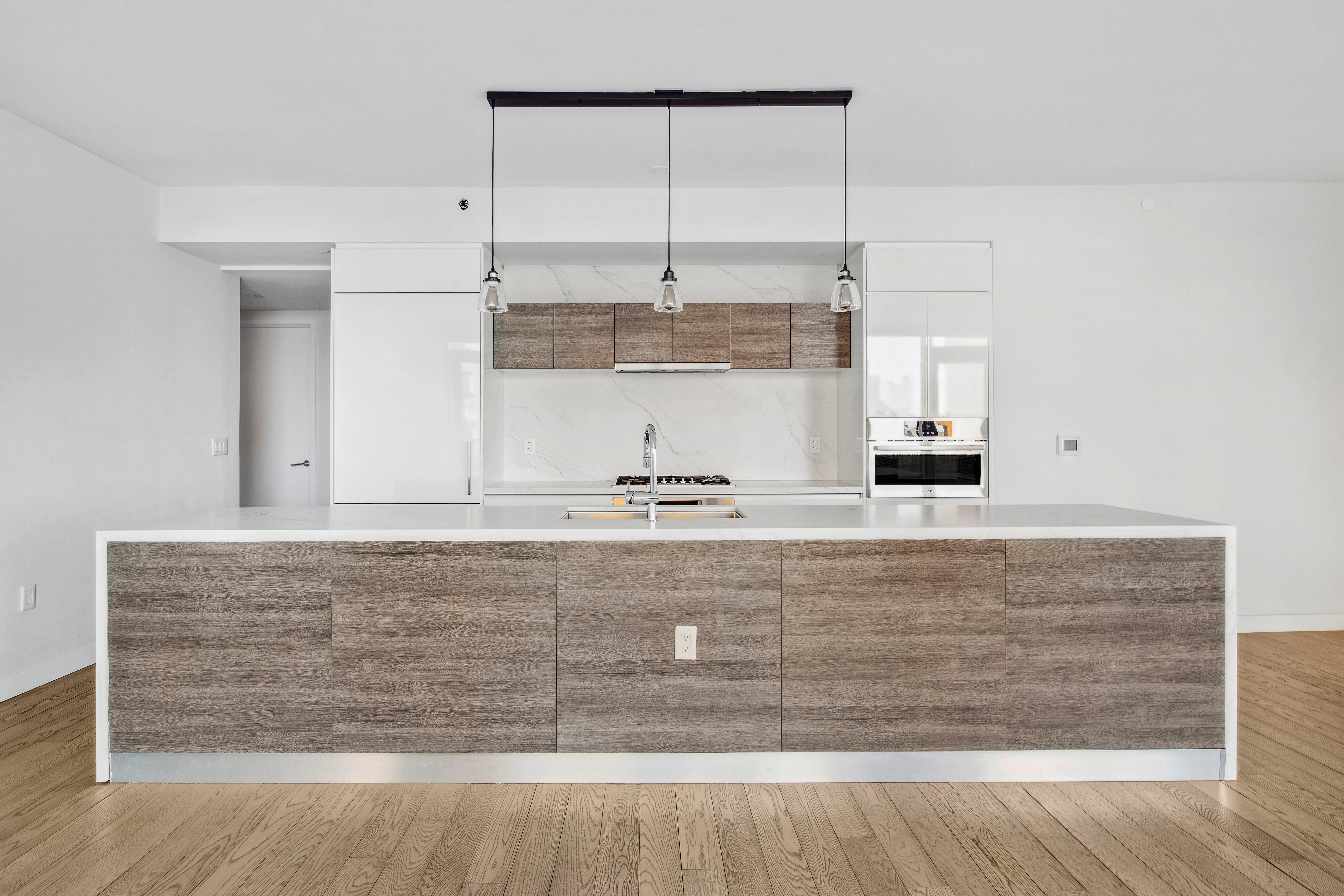 505-513 West 43rd Street, Unit 10B Manhattan, NY 10036 - Photo 3 of 22 a view with kitchen island sink and refrigerator