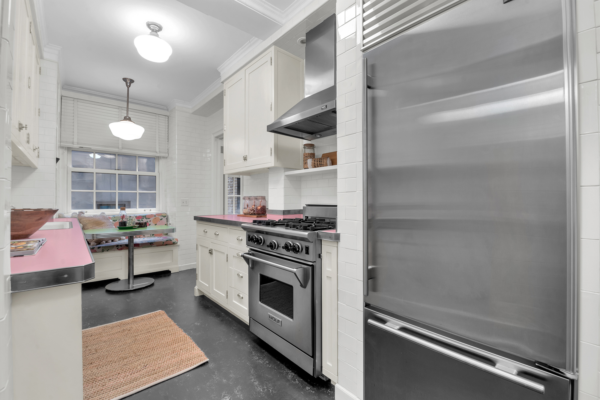 7 Gracie Square, Unit 5A Manhattan, NY 10128 - Photo 19 of 26 a kitchen with a stove and white cabinets