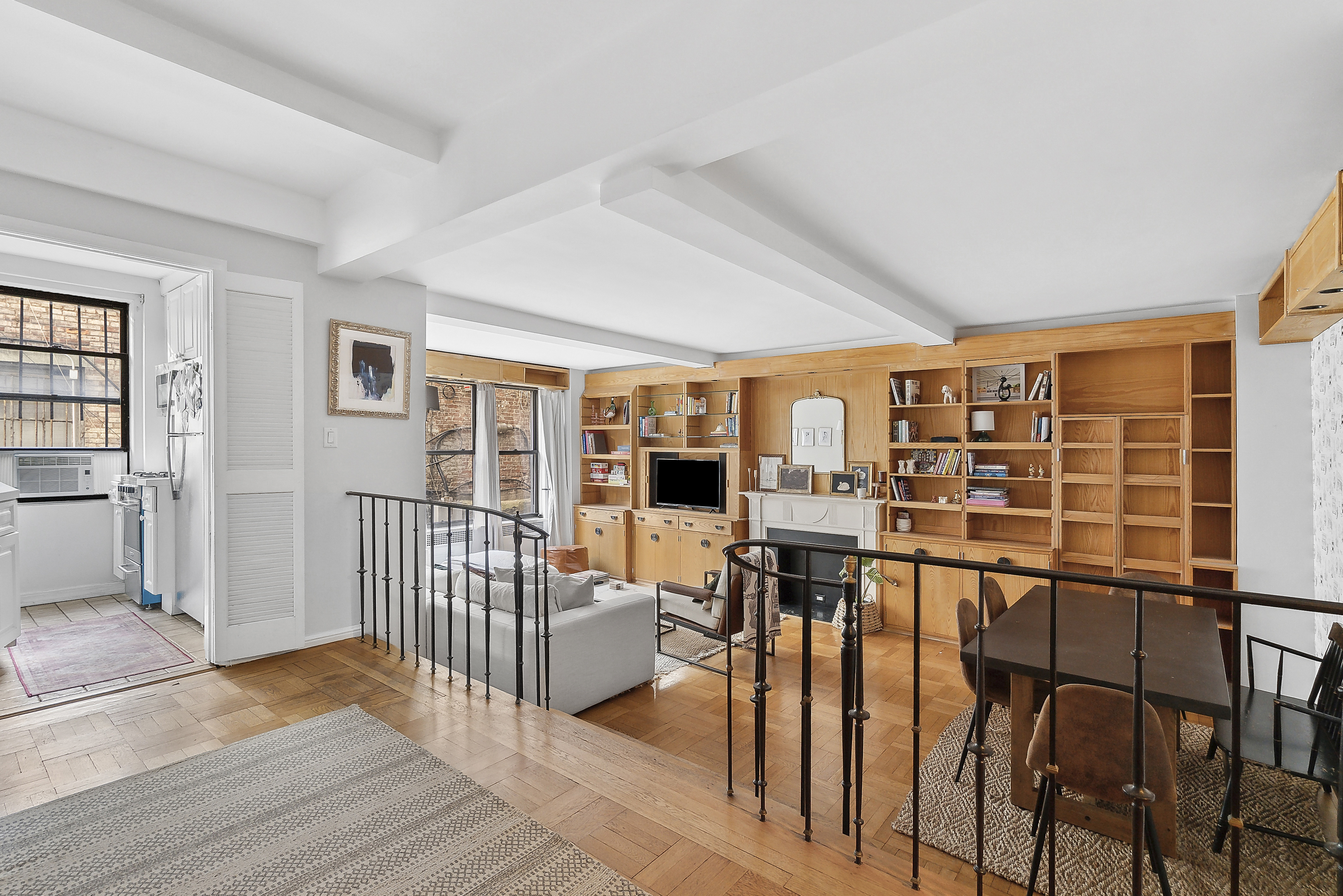 235 East 73rd Street, Unit 1D Manhattan, NY 10021 - Photo 1 of 13 an empty room with wooden floor and windows
