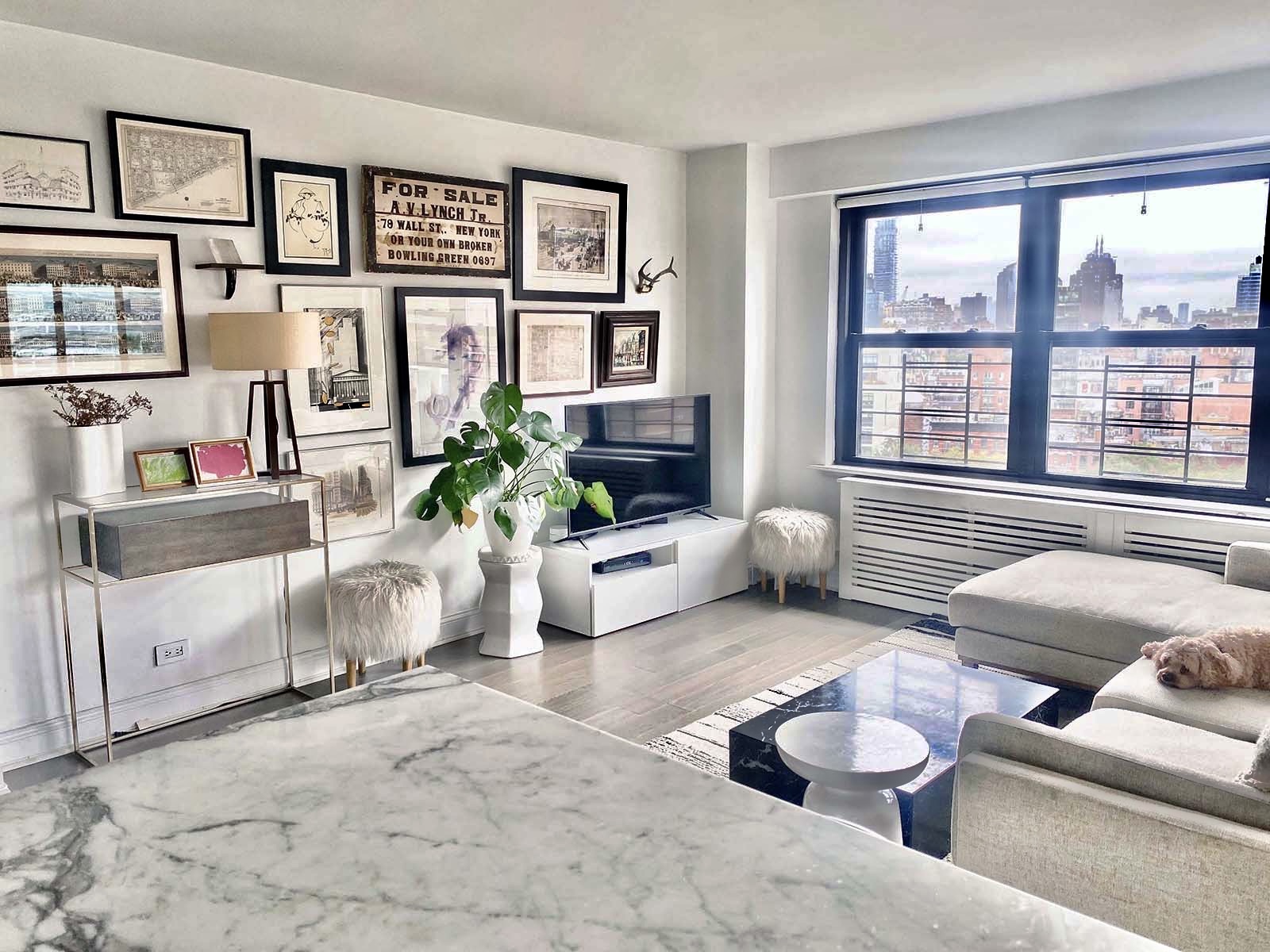 208 East Broadway, Unit J1304 Manhattan, NY 10002 - Photo 4 of 19 a living room with furniture and a large window