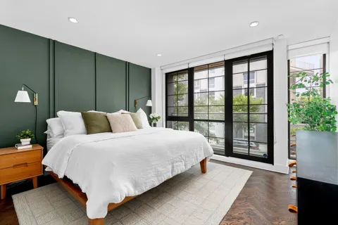 a spacious bedroom with a large bed and a large window
