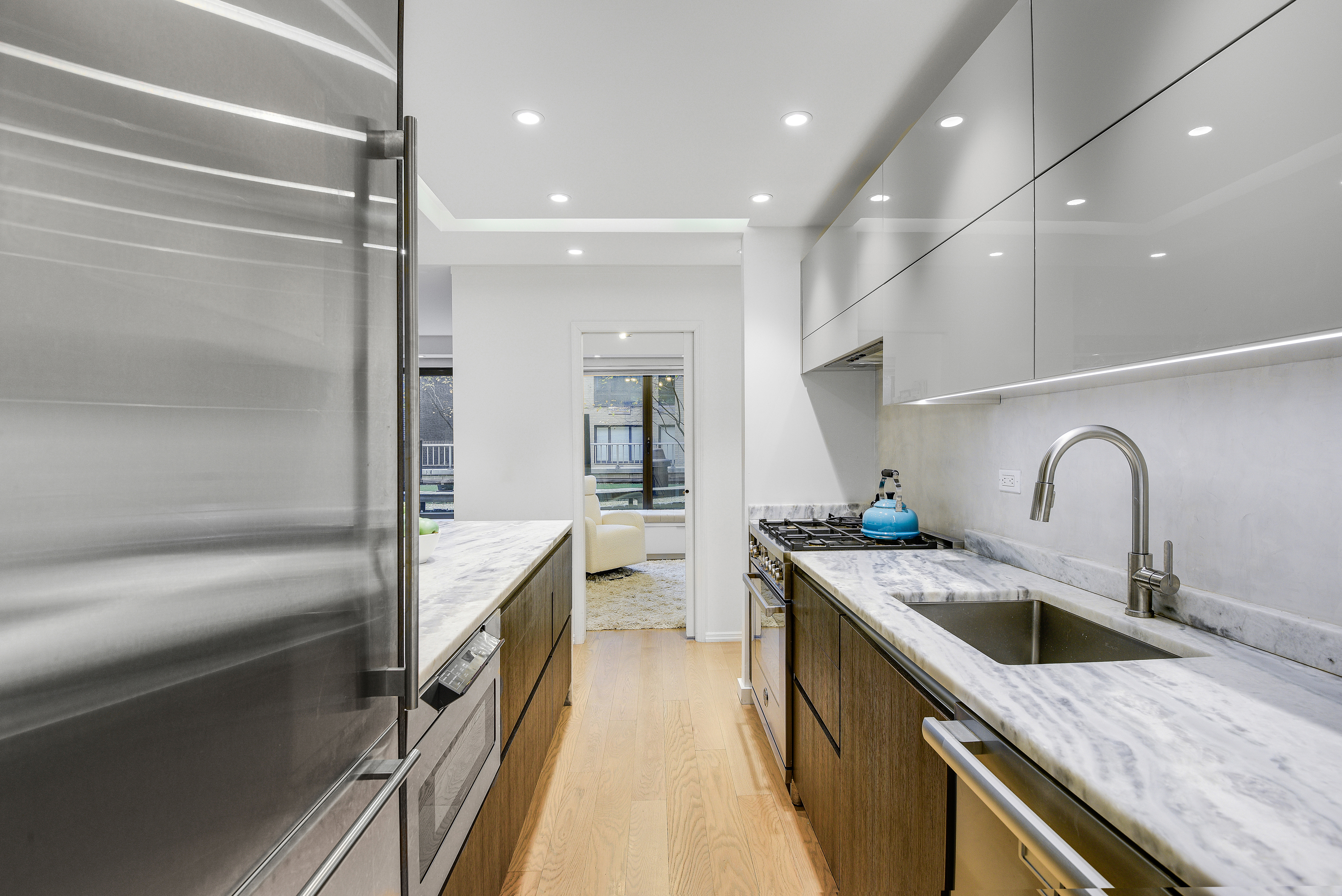 200 Central Park South, Unit 3Q Manhattan, NY 10019 - Photo 6 of 15 a kitchen with a sink stove and refrigerator