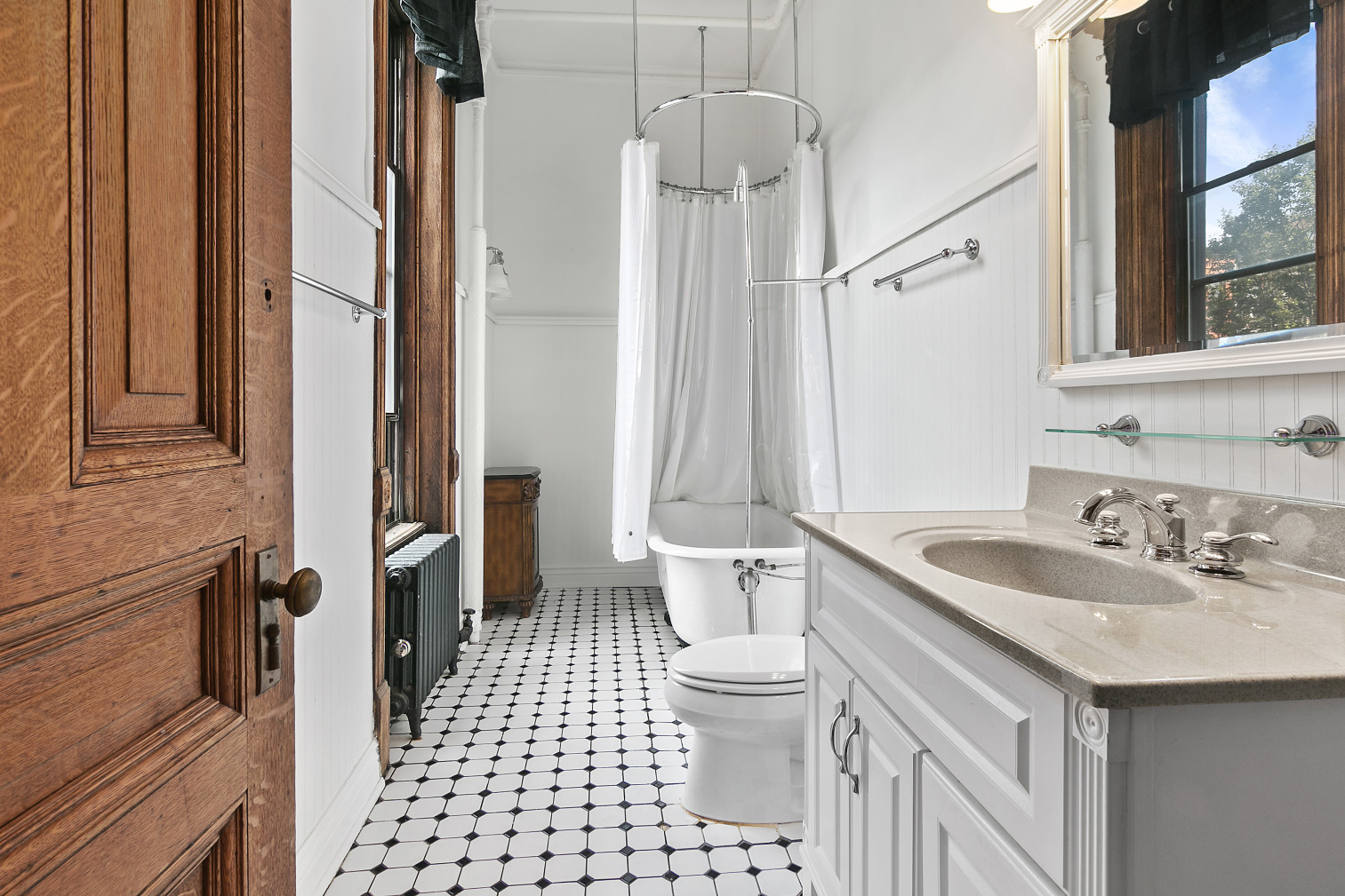 7 West 122nd Street, Unit 3 Manhattan, NY 10027 - Photo 5 of 6 a bathroom with a sink a toilet a mirror and shower