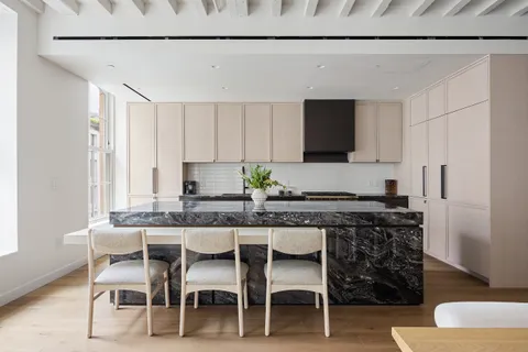 a kitchen with a table and chairs in it